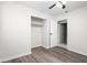 Bedroom with wood-look flooring, closet, neutral walls, and a ceiling fan; creating a calm atmosphere at 6658 Collins Ct, Riverdale, GA 30274
