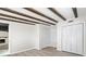 Bedroom featuring wood-look floors, exposed beams, and open access to stone fireplace at 6658 Collins Ct, Riverdale, GA 30274
