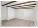 A bright bedroom with wood-look floors, exposed ceiling beams, and ample closet space at 6658 Collins Ct, Riverdale, GA 30274