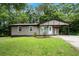 Inviting single story home with a cozy carport and lush green lawn at 6658 Collins Ct, Riverdale, GA 30274