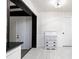 Hallway with white cabinets and a view of a front door and a living room at 6658 Collins Ct, Riverdale, GA 30274