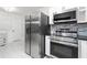 Kitchen with stainless steel refrigerator, oven, microwave, and glass tile backsplash at 6658 Collins Ct, Riverdale, GA 30274