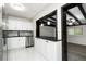 Bright kitchen with stainless steel appliances, white cabinets, and black countertops at 6658 Collins Ct, Riverdale, GA 30274