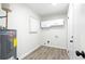 Well-lit laundry room featuring storage cabinets, washer/dryer hookups, and an exterior door at 6658 Collins Ct, Riverdale, GA 30274