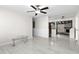 Bright living room with sleek tile floors and an open layout to the kitchen at 6658 Collins Ct, Riverdale, GA 30274