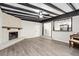 Open living room features fireplace, wood-look floors, and seamless access to the kitchen at 6658 Collins Ct, Riverdale, GA 30274