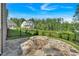 Stone paver patio with built-in stone fire pit, fenced yard, and view of home at 1065 Low Water Crossing Nw, Acworth, GA 30101
