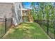 Fenced backyard with upper-level wooden deck and lower level covered stained patio at 1065 Low Water Crossing Nw, Acworth, GA 30101