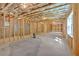 Unfinished basement with concrete floor, exposed ceiling and framing, and window at 1065 Low Water Crossing Nw, Acworth, GA 30101