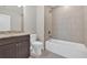 Bathroom featuring dark cabinets, a granite countertop, toilet, a tub, and tile walls at 1065 Low Water Crossing Nw, Acworth, GA 30101
