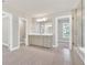 Bright bathroom with double sink vanity, walk-in closet, glass shower, tub, and neutral color palette at 1065 Low Water Crossing Nw, Acworth, GA 30101