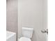 Bathroom with white toilet and gray tiled walls near the bathtub at 1065 Low Water Crossing Nw, Acworth, GA 30101