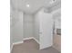 Empty walk-in closet with shelving, carpet, and doorway leading to bathroom at 1065 Low Water Crossing Nw, Acworth, GA 30101