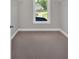 Empty walk-in closet with shelving, carpet, and natural light from window at 1065 Low Water Crossing Nw, Acworth, GA 30101