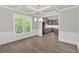 Dining room features coffered ceiling, wainscoting, and view into the kitchen through open doorway at 1065 Low Water Crossing Nw, Acworth, GA 30101