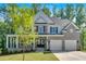 Charming two-story home with a manicured lawn, stone accents, and an attached two-car garage at 1065 Low Water Crossing Nw, Acworth, GA 30101