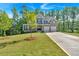 Well-maintained lawn and landscaping highlight this attractive two-story house with a long driveway at 1065 Low Water Crossing Nw, Acworth, GA 30101