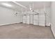 Empty two car garage with white walls, cement floors, and two white garage doors at 1065 Low Water Crossing Nw, Acworth, GA 30101