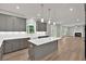 Open concept kitchen with gray cabinets, quartz countertops, large island, and view to living room at 1065 Low Water Crossing Nw, Acworth, GA 30101