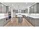 Spacious gray kitchen with center island, quartz countertops, stainless steel appliances, and ample cabinet space at 1065 Low Water Crossing Nw, Acworth, GA 30101