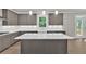 Well lit gray kitchen featuring stainless steel appliances, a large island, and white quartz countertops at 1065 Low Water Crossing Nw, Acworth, GA 30101