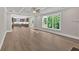 Open concept living room boasts hardwood floors, large windows, and view into the kitchen at 1065 Low Water Crossing Nw, Acworth, GA 30101