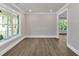 Living room featuring wood flooring and bright natural light from the windows at 1065 Low Water Crossing Nw, Acworth, GA 30101