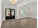 Bright living room boasts hardwood floors, large window and glass front door allowing tons of natural light at 1065 Low Water Crossing Nw, Acworth, GA 30101