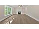 Bright living room features hardwood floors, large window, coffered ceiling, and fireplace at 1065 Low Water Crossing Nw, Acworth, GA 30101