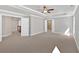 Main bedroom with tray ceilings, neutral carpet and multiple entryways at 1065 Low Water Crossing Nw, Acworth, GA 30101