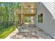 Covered patio with stained concrete floor and steps to upper level deck with ceiling fan at 1065 Low Water Crossing Nw, Acworth, GA 30101