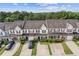 Aerial view of townhomes with manicured lawns and mature trees at 2183 Miranda Dr, Morrow, GA 30260