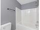 Bathroom with a white shower-tub combination, tiled surround and modern fixtures at 2183 Miranda Dr, Morrow, GA 30260