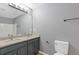 Bathroom vanity with double sinks, granite countertop, framed mirror, and modern fixtures at 2183 Miranda Dr, Morrow, GA 30260