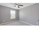 Bedroom features neutral paint, a ceiling fan, and a large window at 2183 Miranda Dr, Morrow, GA 30260