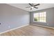 Bright bedroom with hardwood floors, a ceiling fan, and a large window at 2183 Miranda Dr, Morrow, GA 30260