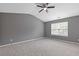 This bedroom is finished with neutral paint, a window, and a ceiling fan at 2183 Miranda Dr, Morrow, GA 30260