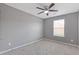 Bedroom features neutral paint, a ceiling fan, and a large window at 2183 Miranda Dr, Morrow, GA 30260