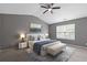 Staged main bedroom features neutral colors, a ceiling fan and a window at 2183 Miranda Dr, Morrow, GA 30260