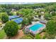 This community aerial view showcases well maintained tennis courts, pool, and grounds in a parklike setting at 245 River Laurel Way, Woodstock, GA 30188