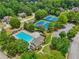 Aerial view showcasing a community pool, tennis courts, and surrounding lush greenery at 245 River Laurel Way, Woodstock, GA 30188