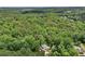 Extensive aerial shot of dense forest neighborhood with house at 245 River Laurel Way, Woodstock, GA 30188