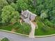An aerial view of a beautiful home featuring landscaped grounds, mature trees, and a welcoming driveway at 245 River Laurel Way, Woodstock, GA 30188