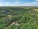 Wide aerial view of the house surrounded by dense trees in a residential area at 245 River Laurel Way, Woodstock, GA 30188