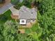 Bird's eye view of the house highlighting roof, chimney, and surrounding greenery at 245 River Laurel Way, Woodstock, GA 30188