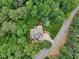 Aerial view of a home featuring a well-manicured lawn, mature trees, and a welcoming outdoor space at 245 River Laurel Way, Woodstock, GA 30188