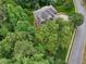 Aerial view showcases a house surrounded by mature trees, providing both privacy and a natural aesthetic at 245 River Laurel Way, Woodstock, GA 30188