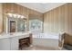 Bright bathroom featuring a soaking tub, vanity with sink, and decorative window at 245 River Laurel Way, Woodstock, GA 30188