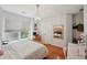 Sunlit bedroom with hardwood floors, white walls, and window blinds at 245 River Laurel Way, Woodstock, GA 30188