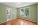 Inviting bedroom featuring hardwood floors, view of an adjacent bathroom, and a bright window at 245 River Laurel Way, Woodstock, GA 30188